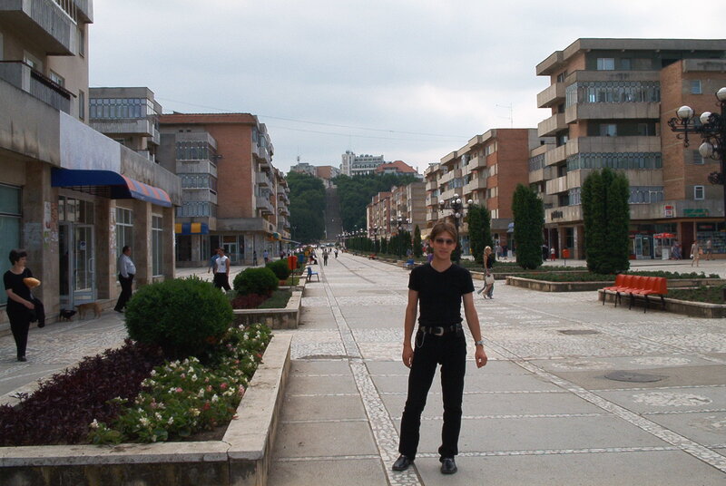 Person Standing on Sidewalk — Gray