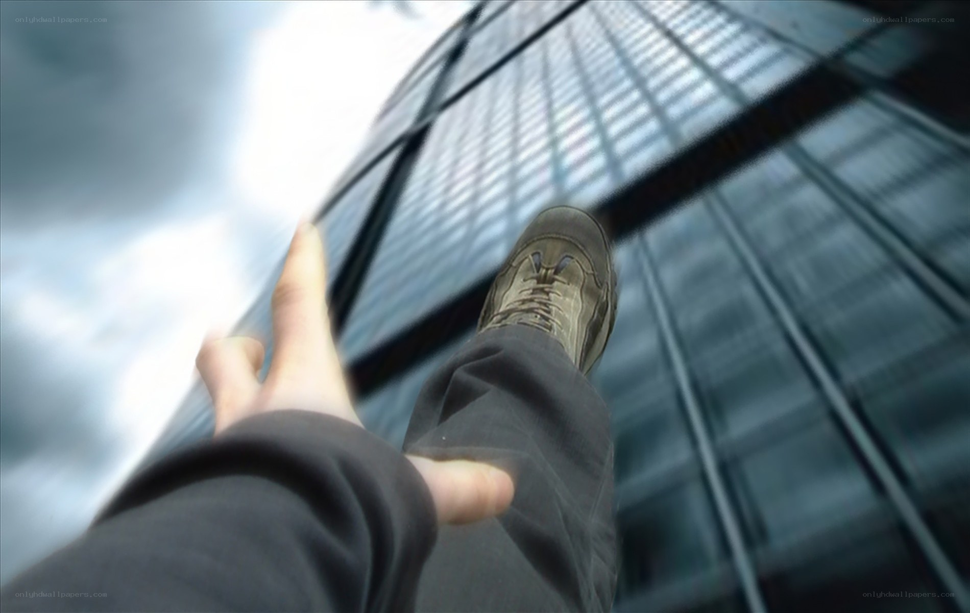 person standing on skyscraper edge
