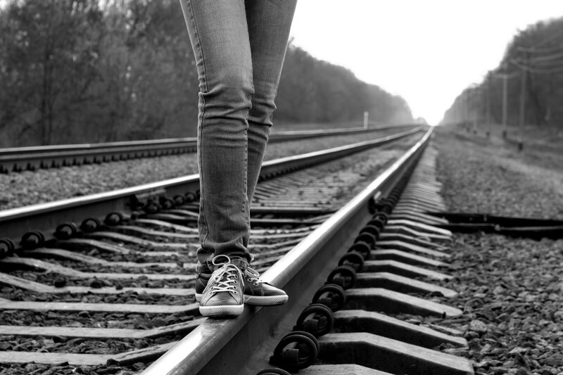 Person Standing on Train Tracks — Black