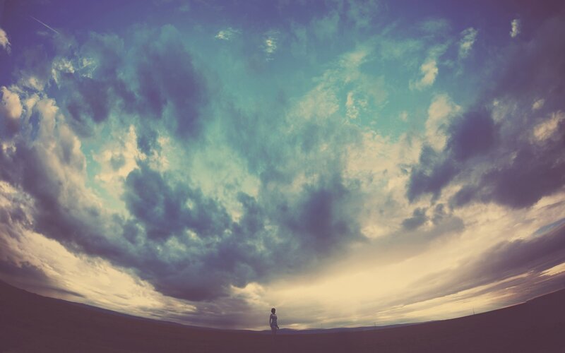Person standing under dramatic sky