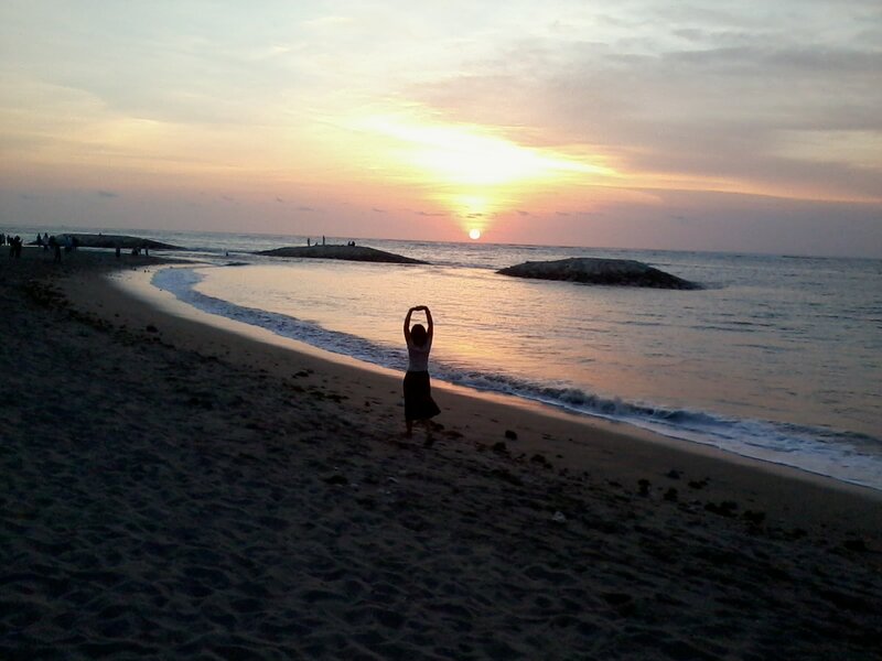 Person Stretching on Beach — Orange
