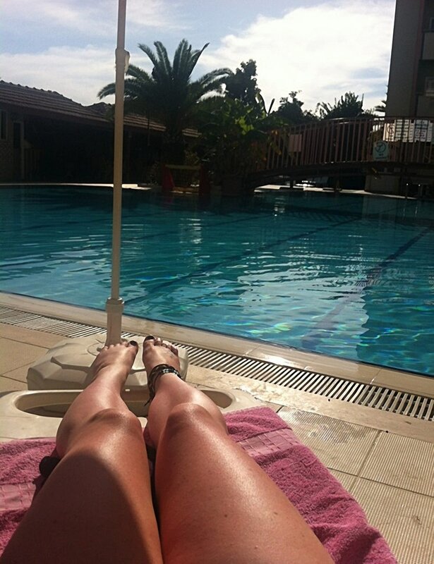 Person Sunbathing by Pool — Blue, Relaxed, Afternoon