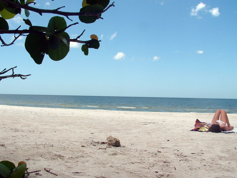 Person Sunbathing on Beach — Blue