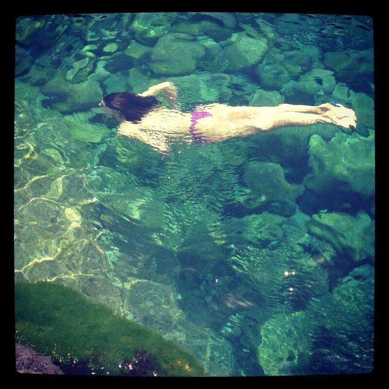 person swimming in clear water
