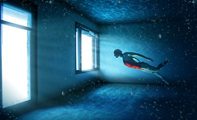 person swimming underwater in room