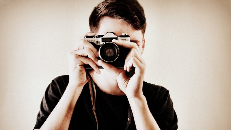 person taking a photo with vintage camera