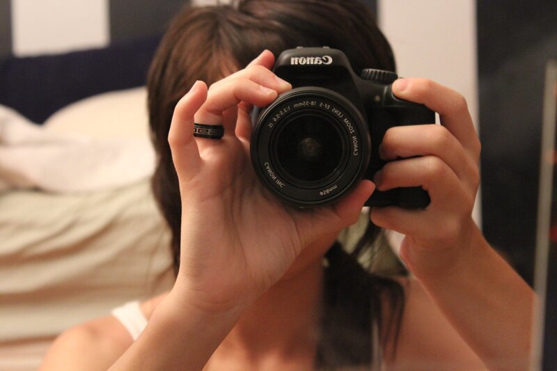 person taking mirror selfie with camera