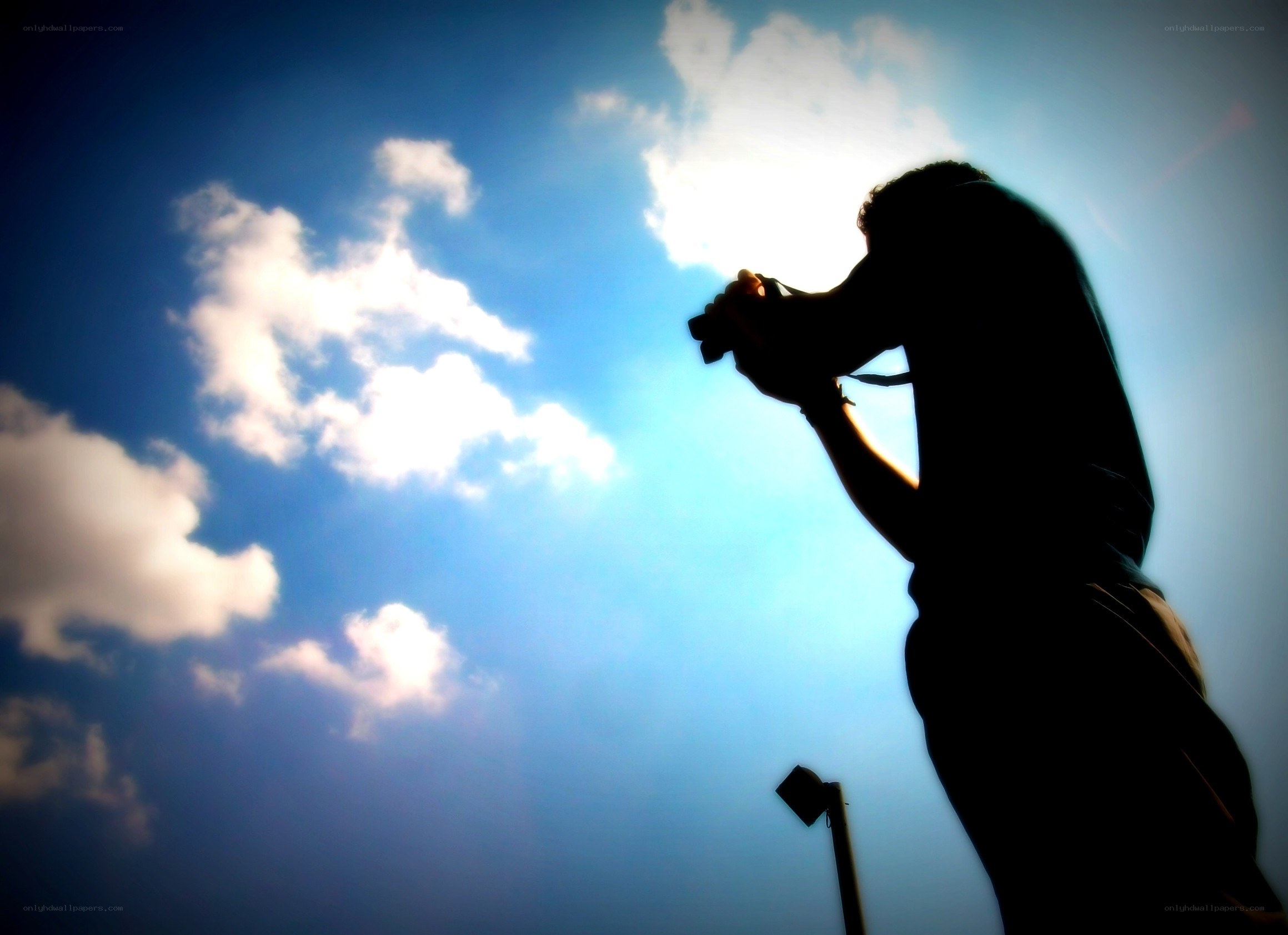 person taking photo against sky