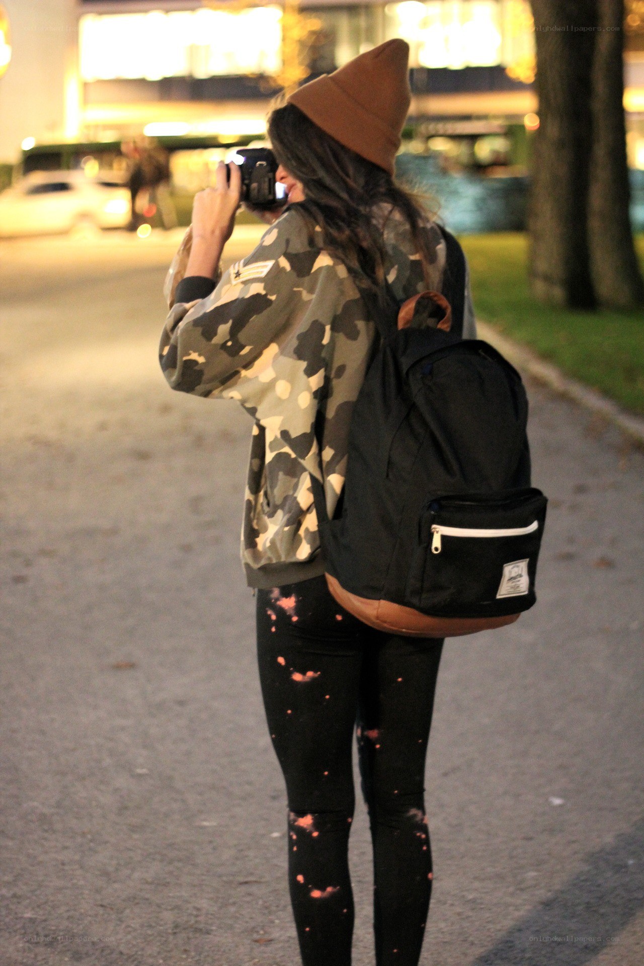 person taking photo at night