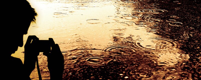 person taking photo in rain