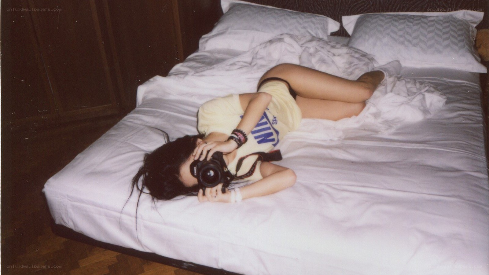 person taking photo on bed