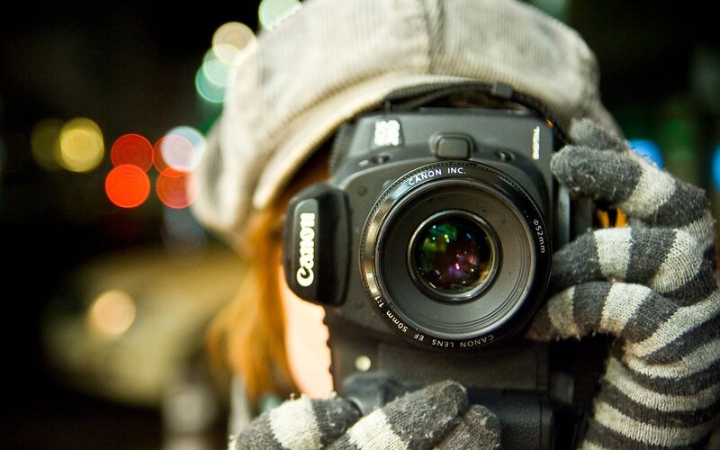person taking photo with canon camera