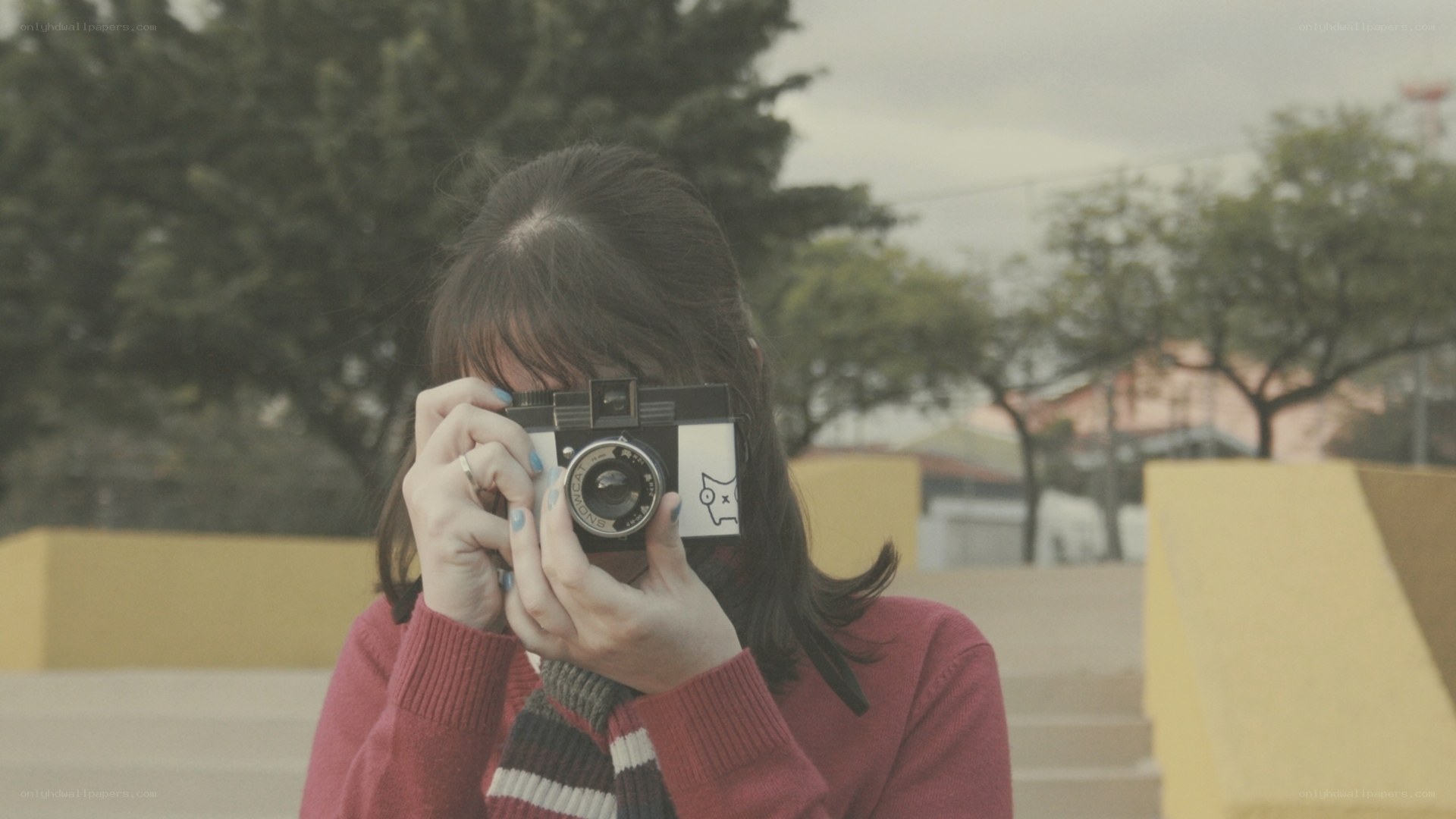 person taking photo with vintage camera