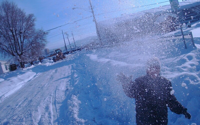Person throwing snow in winter