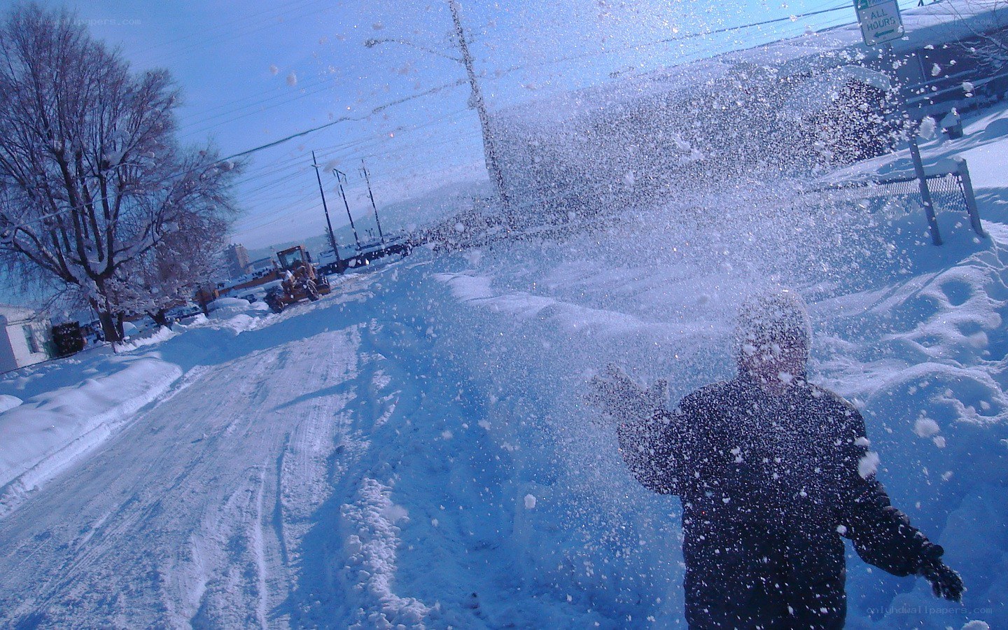 Person throwing snow in winter