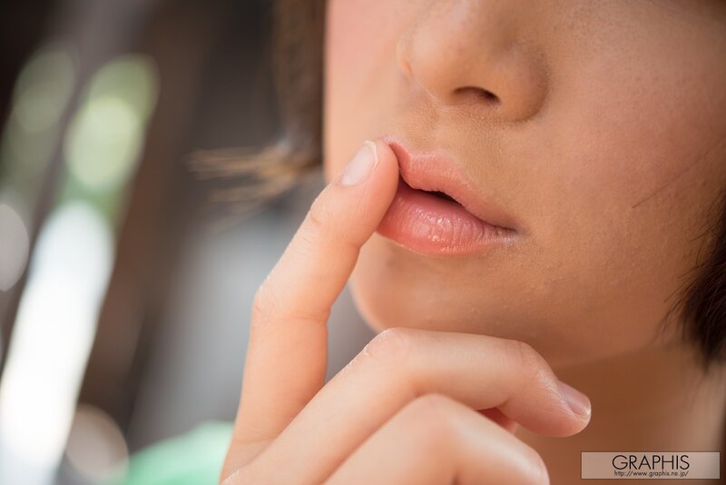 person touching lips with finger