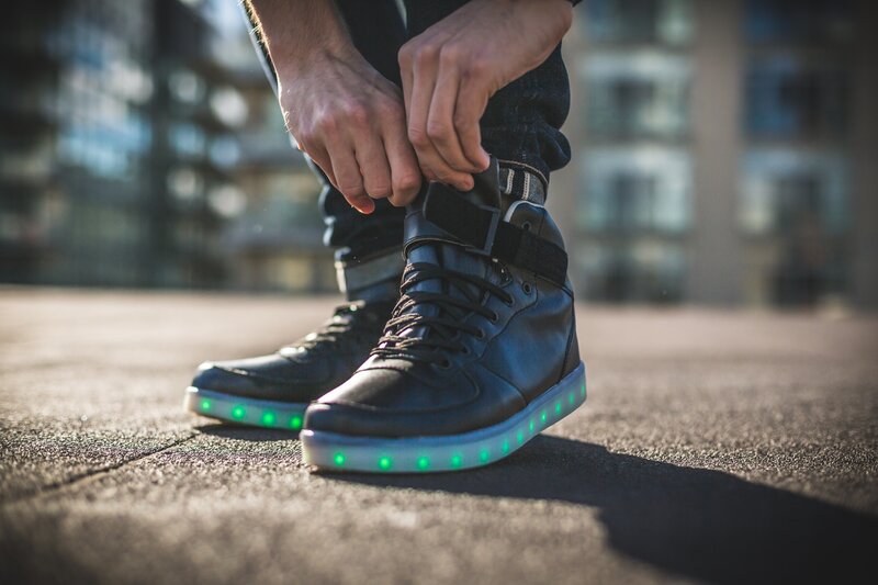 person tying glowing shoes