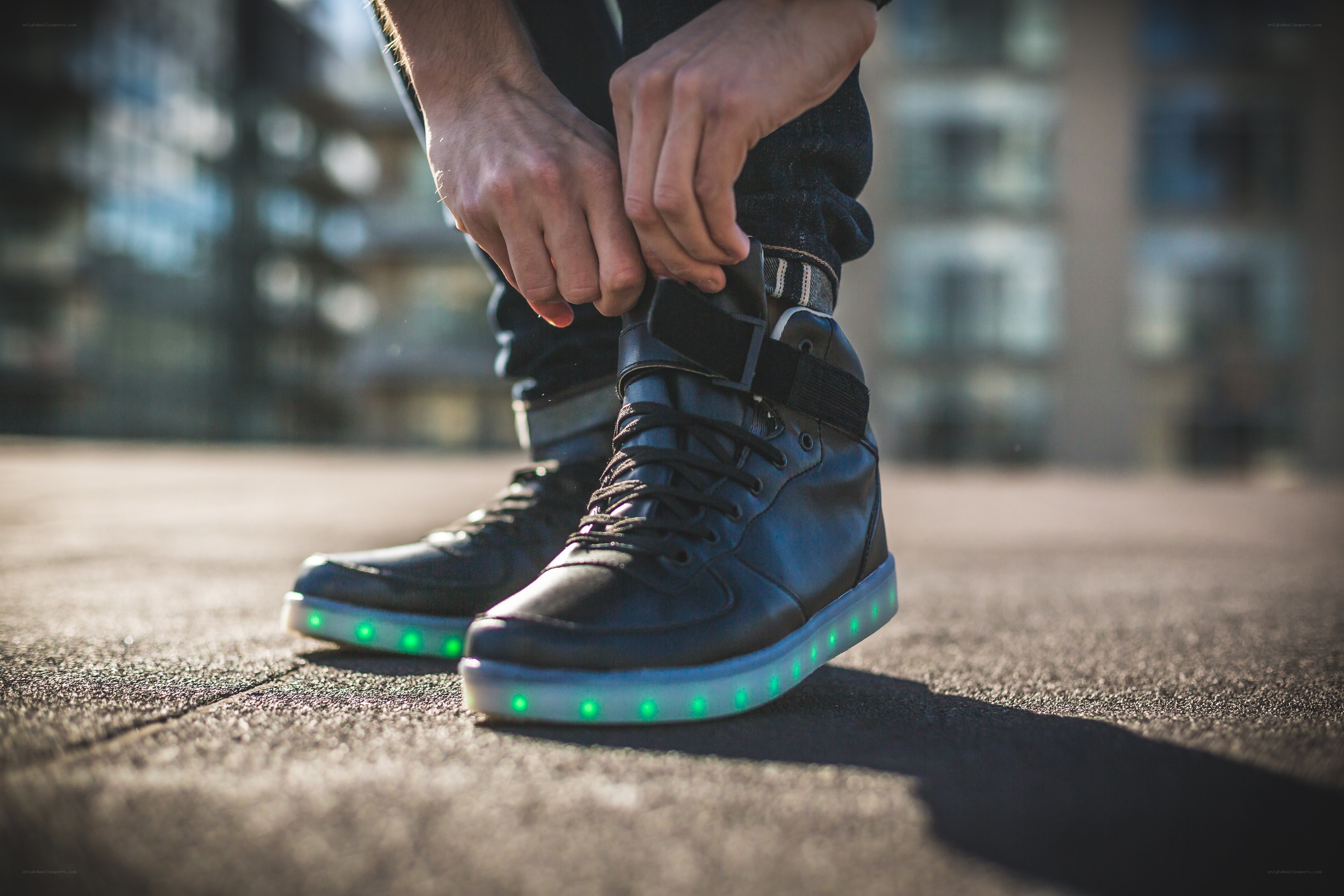 person tying glowing shoes