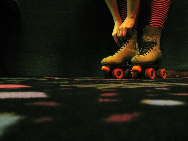 person tying roller skates