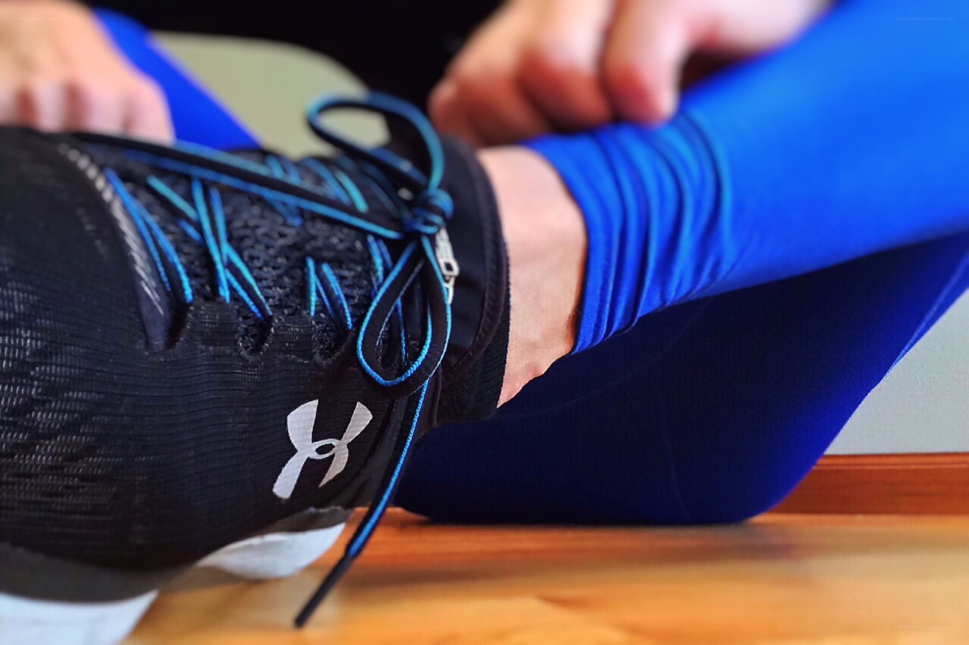 person tying running shoes
