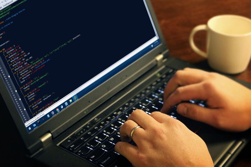 Person Typing on Laptop