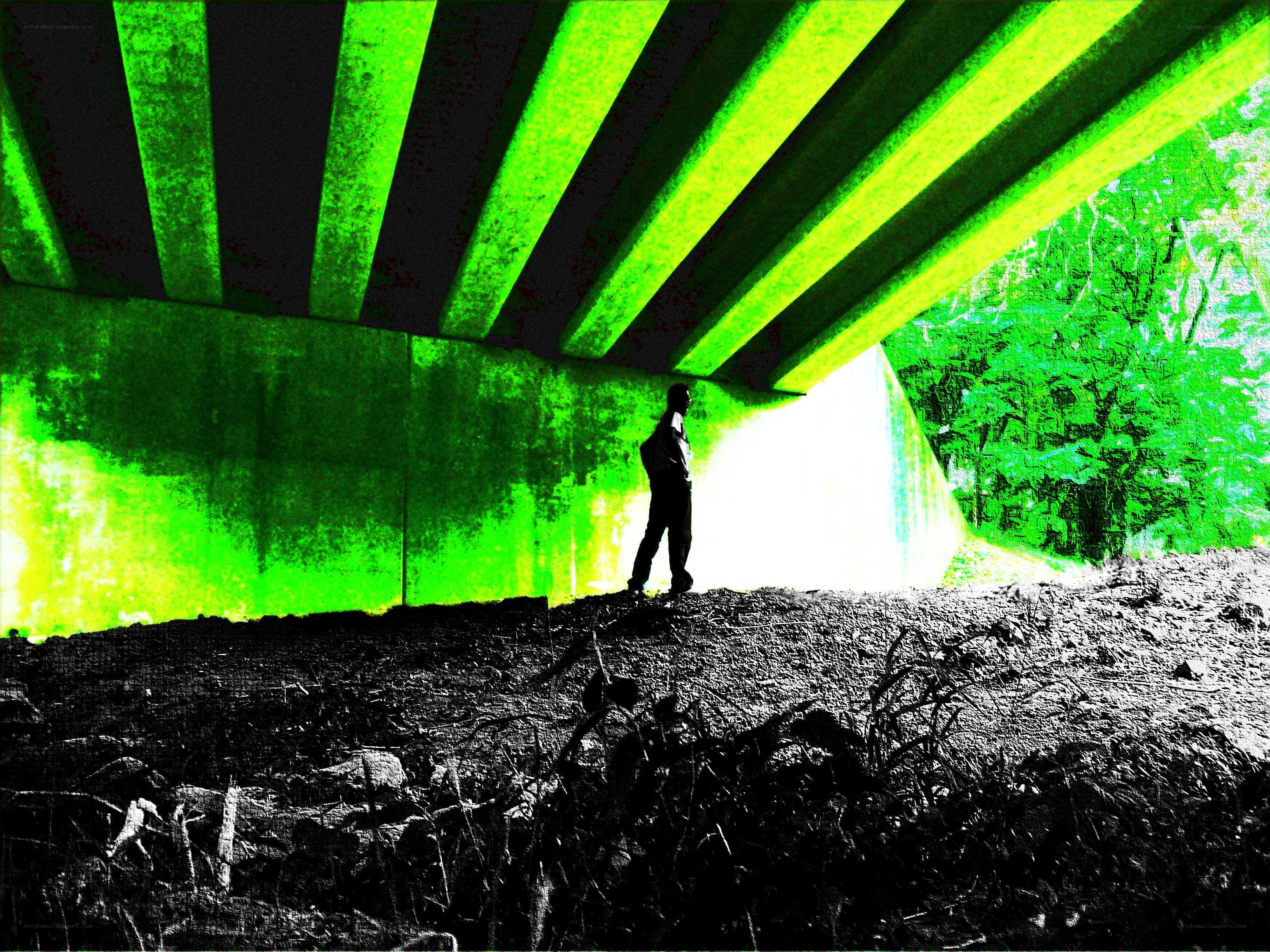 Person under a bridge at night