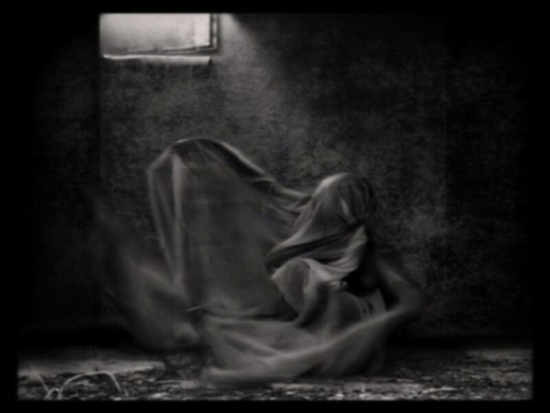 Person under Cloth in Dark Room