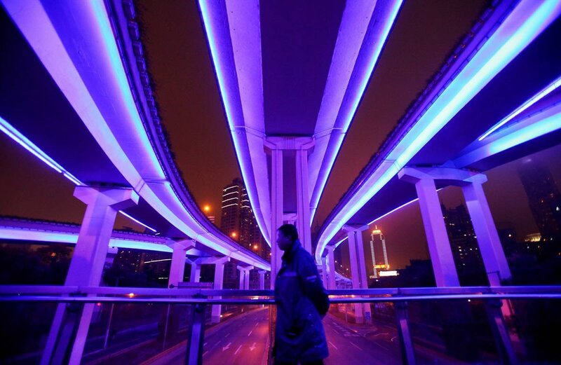 Person under illuminated highway at night