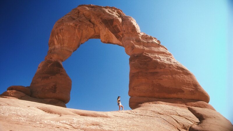 Person under Rock Arch — Blue