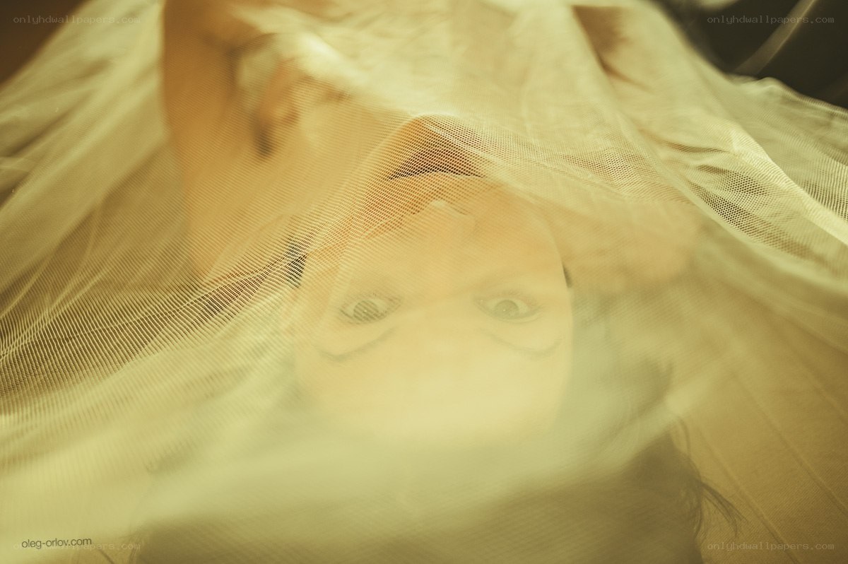 person under sheer fabric