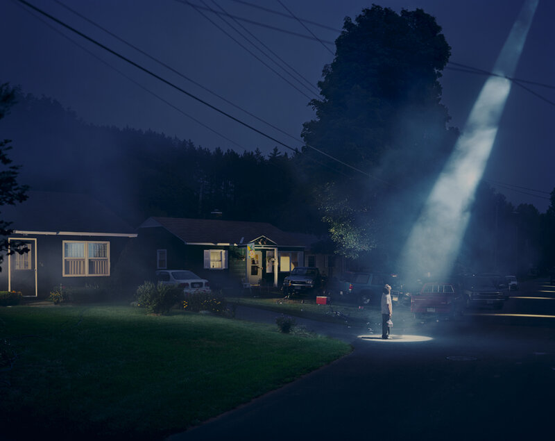 person under spotlight at night