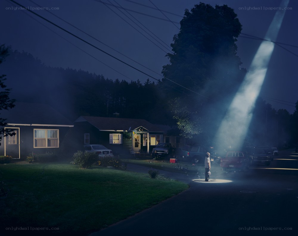 person under spotlight at night