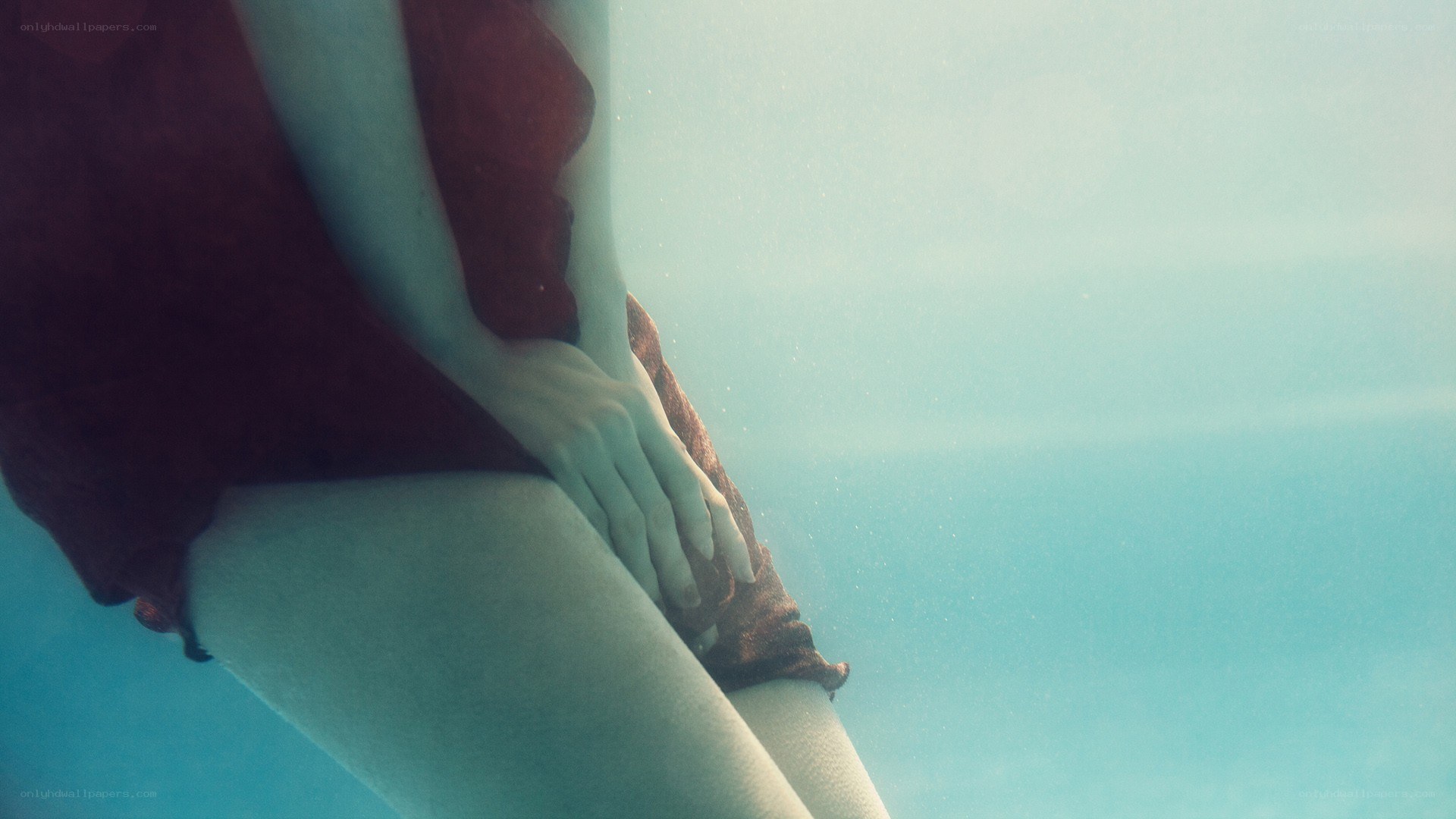 person underwater in red garment