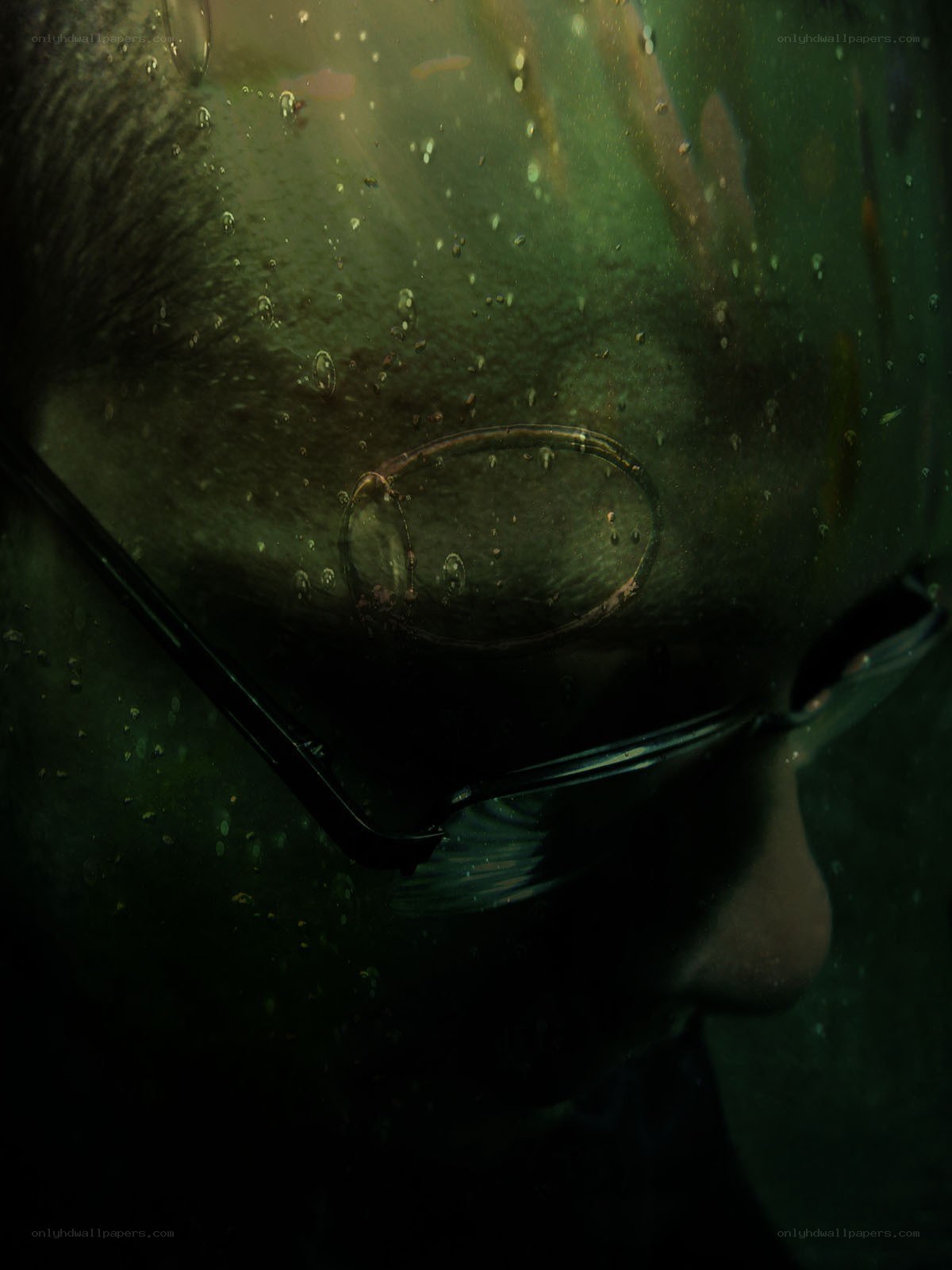 person underwater with glasses