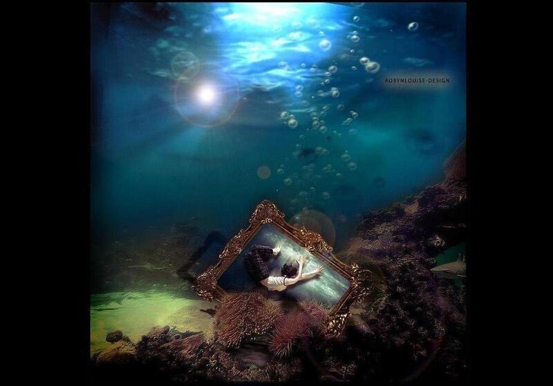 person underwater with mirror
