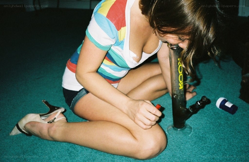 person using a bong on the floor