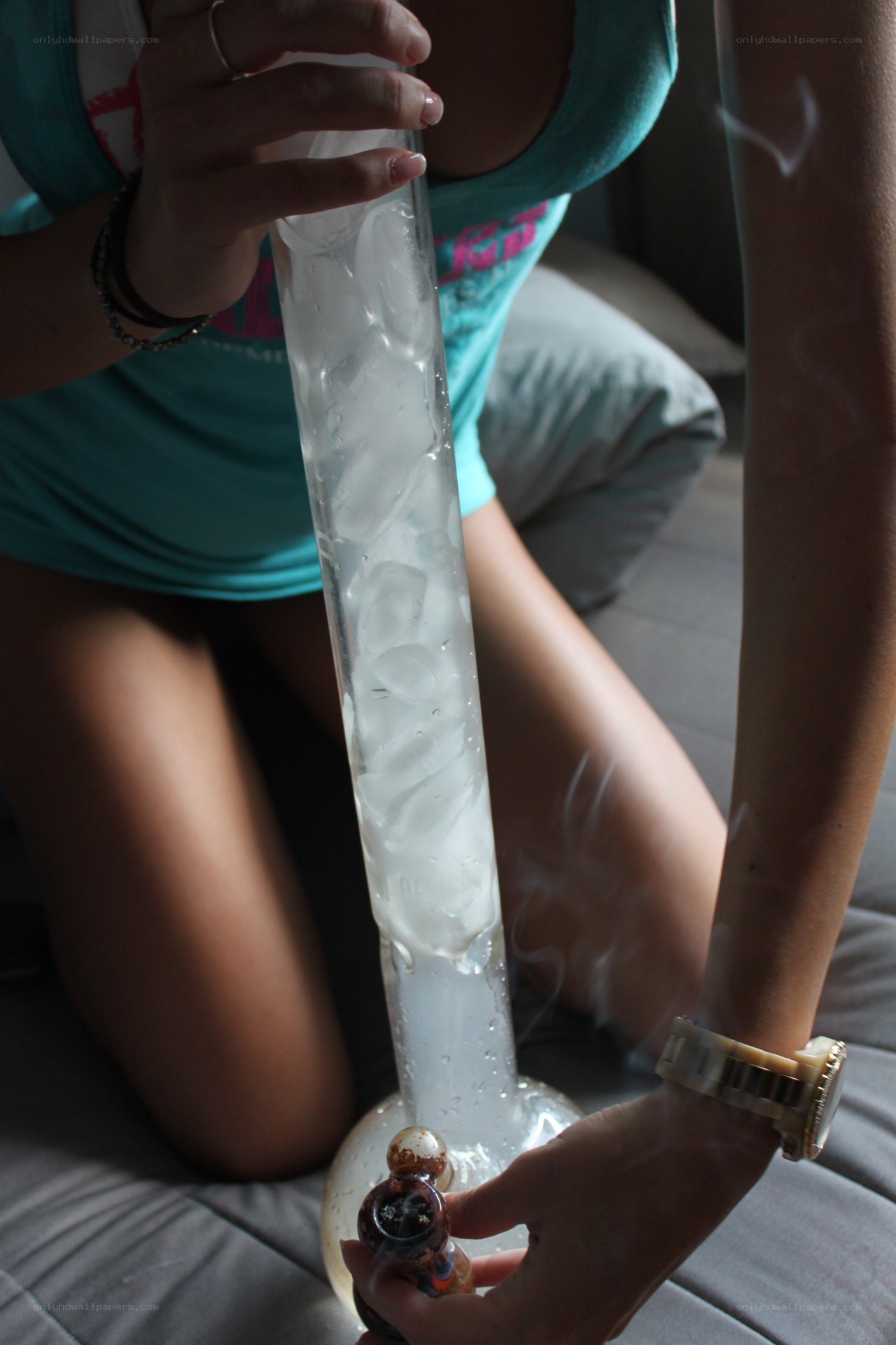 person using a bong with ice