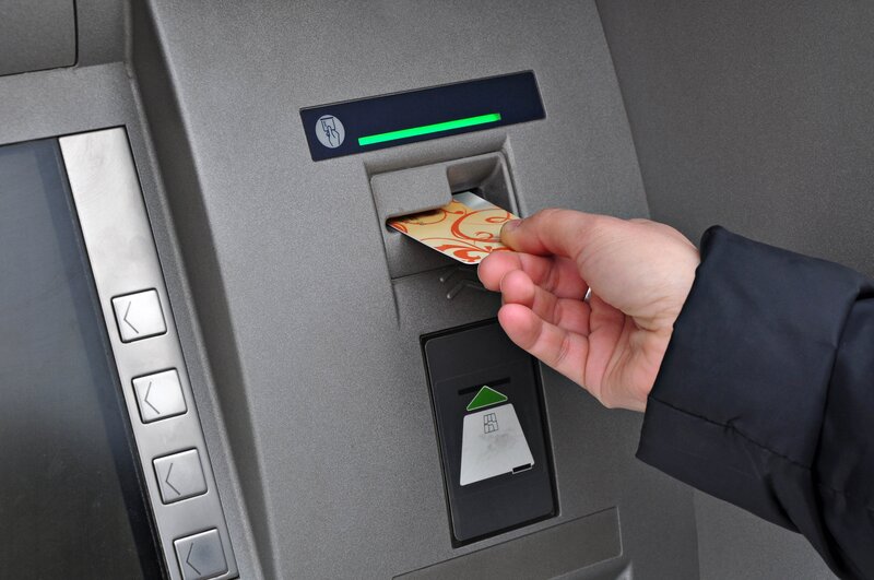 Person using ATM machine