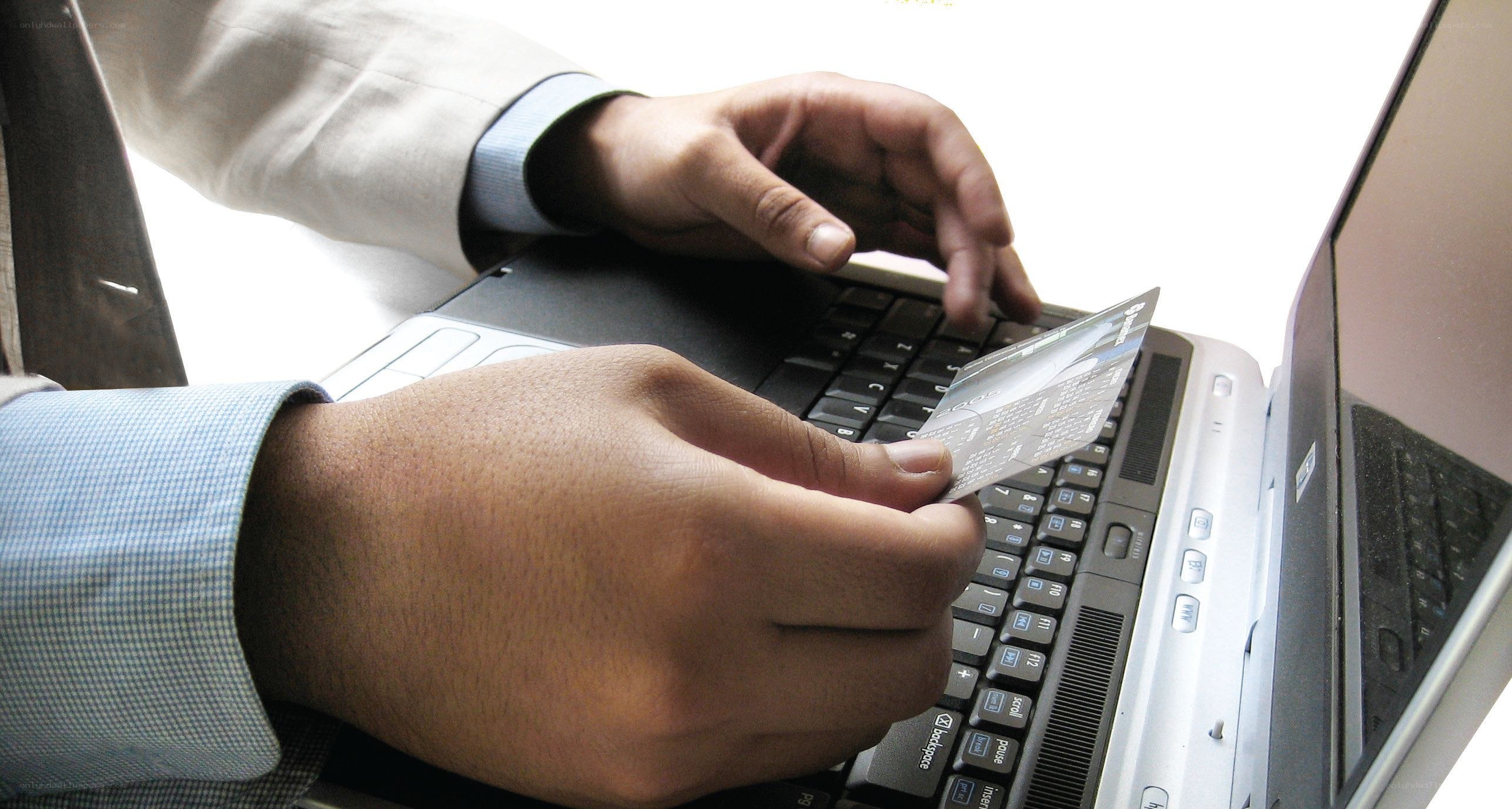 person using credit card on laptop