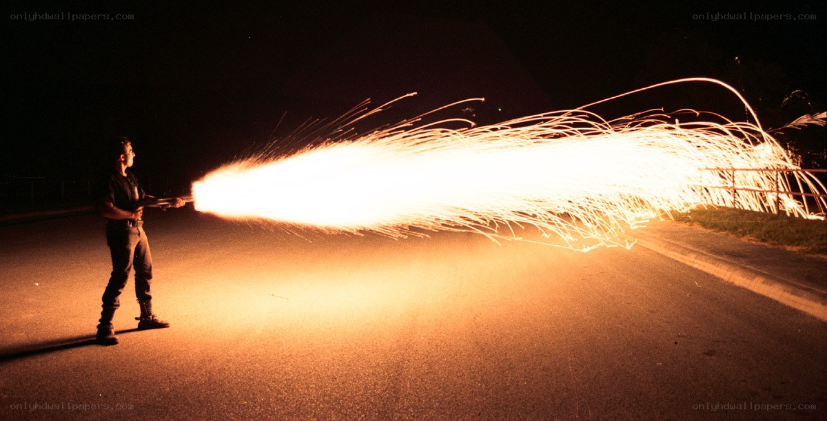 Person using flamethrower at night