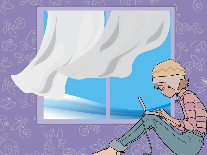 person using laptop by window