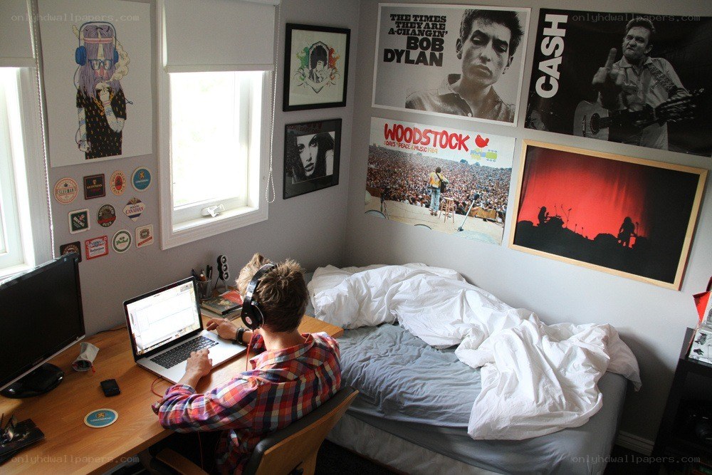 person using laptop in bedroom