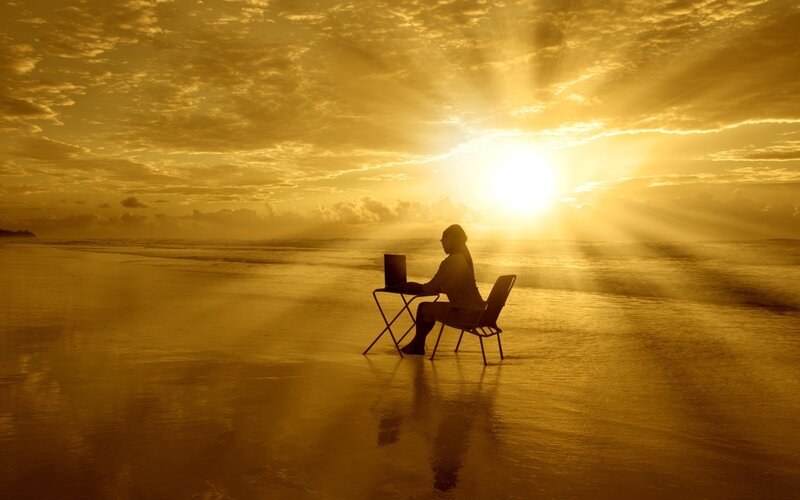Person Using Laptop on Beach — Gold