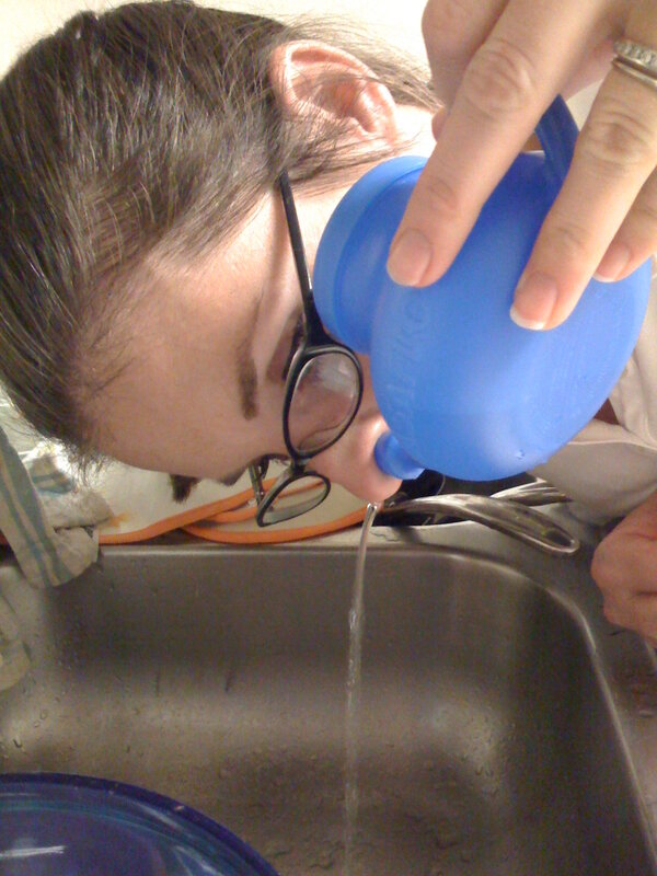 person using neti pot