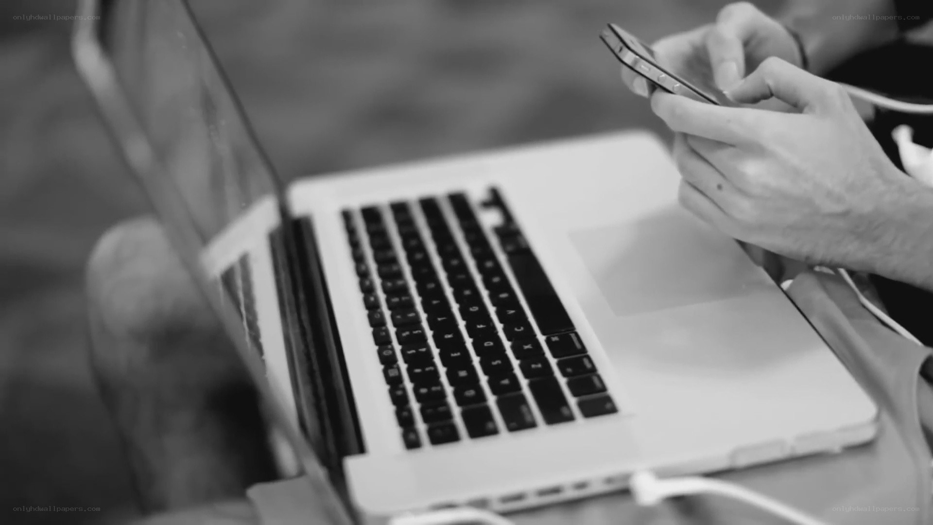 person using phone and laptop