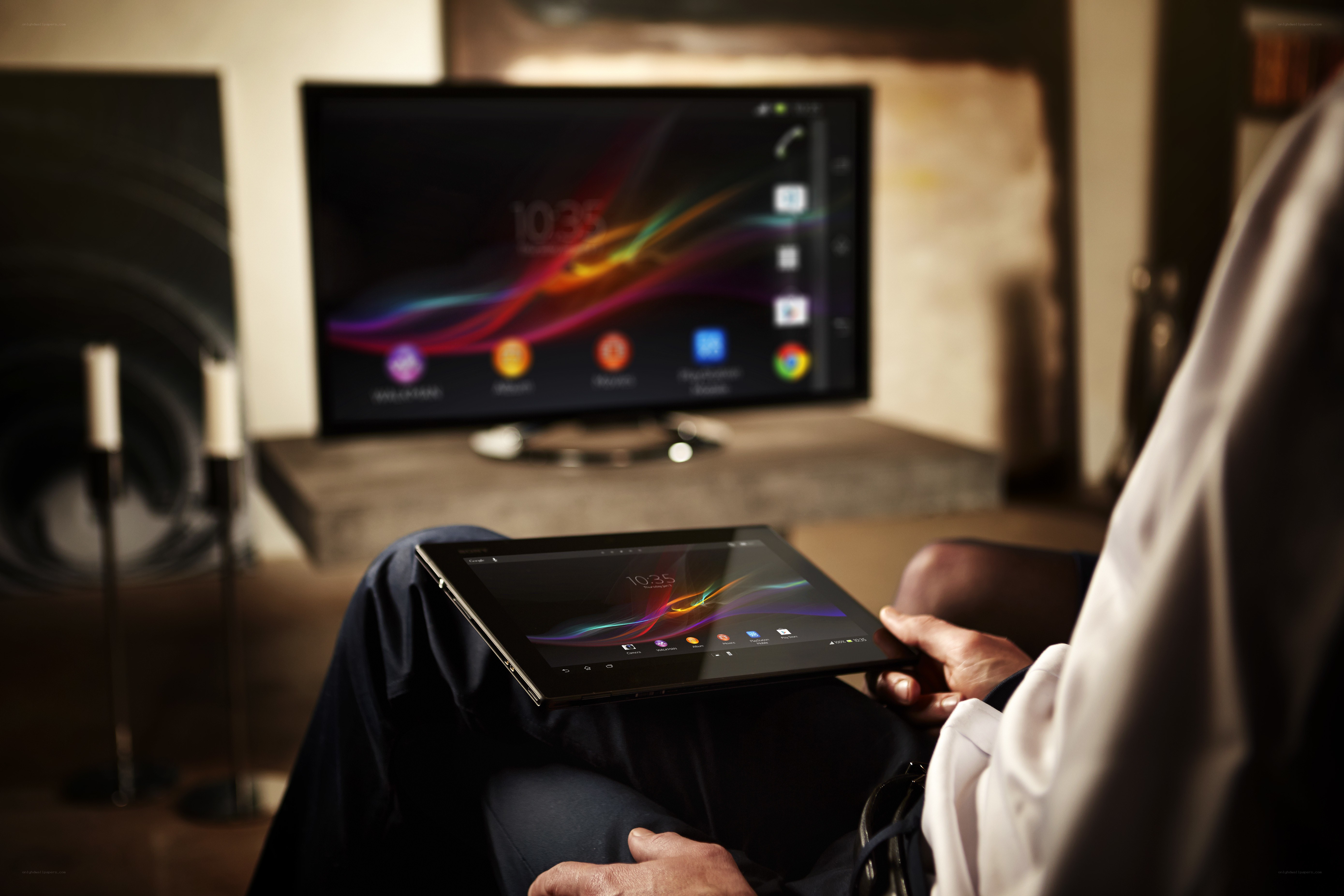 person using tablet in living room