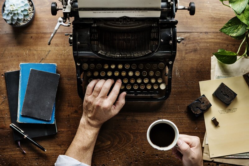 Person Using Typewriter — Brown
