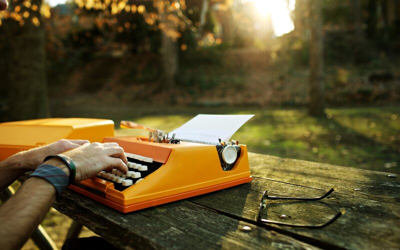 Person Using Typewriter