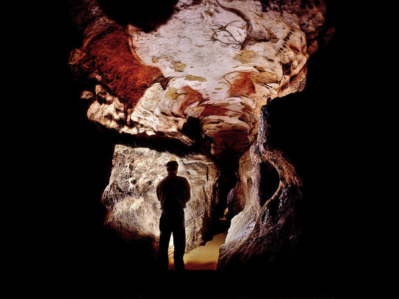 Person viewing cave paintings