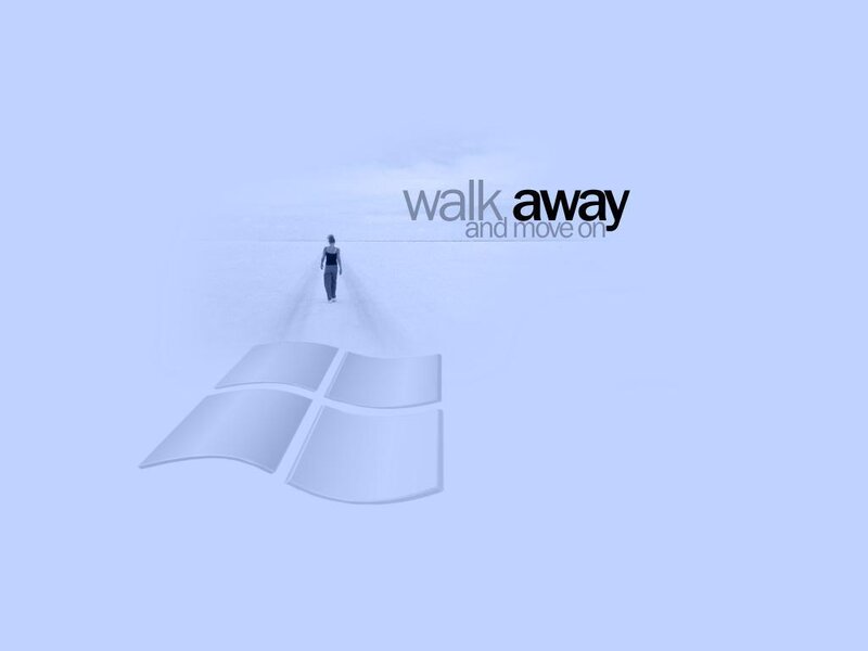 person walking away from Windows logo